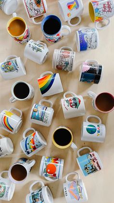 many different coffee mugs on a table