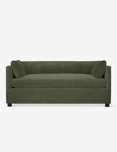 a green couch sitting on top of a white floor