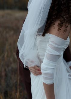 the bride and groom are standing close together