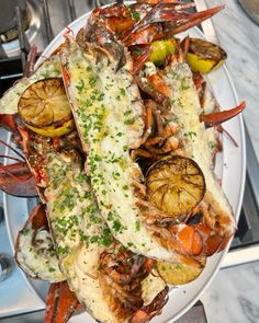 a white plate topped with lobster and potatoes