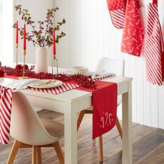 the table is set with red and white decorations