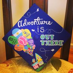 a blue graduation cap that says adventure is out there