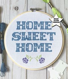 a cross - stitch pattern with the words home sweet, sweet home in blue and purple