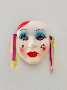 a clown mask hanging on the wall