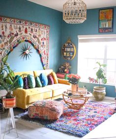 a living room filled with furniture and lots of colorful pillows on top of a rug