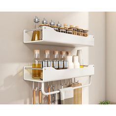 two white shelves filled with different types of bottles and containers on top of each other