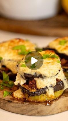 some food is sitting on top of a wooden board with green garnishes