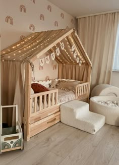 a child's bedroom with a canopy bed, chair and footstool in it