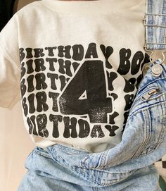 a person wearing a birthday shirt with the number four printed on it's chest