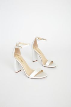 No one does it quite like the Lulus Taylor Ivory Satin Ankle Strap Heels! Whether you choose to dress them up or down, these sleek, satin single sole heels will stun with their slender toe strap, and adjustable ankle strap (with a gold buckle). 4" wrapped block heel. Cushioned insole. Nonskid rubber sole. Upper Material: Fabric. Sole Material: TPR. Imported. Lulus | Taylor Ivory Satin Ankle Strap Heels. Sleek White Formal Sandals, Cute Hoco Heels, Classic Block Heels With Padded Heel For Party, Satin Heels With Padded Heel And Round Toe, Classic Party Block Heels With Padded Heel, White Satin Wedding Shoes For Formal Occasions, Elegant Ankle Strap Block Heels With Branded Heel Counter, Elegant White Block Heels With Contrasting Heel Counter, Satin Open Heels With Padded Heel