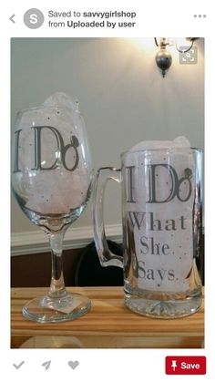 two glass mugs sitting on top of a wooden table next to bottles and glasses