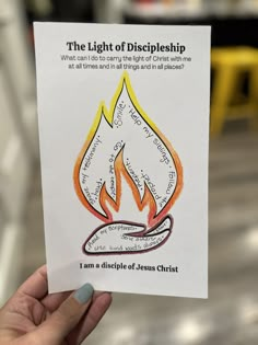 a hand holding up a card with the words, the light of discipleship on it