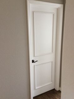 an open white door in the corner of a room