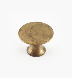 an antique brass cabinet knob on a white background