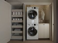 a washer and dryer are in the closet next to each other with toilet paper