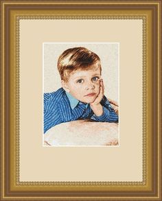 a young boy with his hand on his chin, in a gold framed photo frame