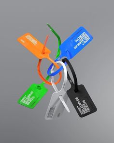 an assortment of luggage tags hanging from a metal hook on a gray background with the tag attached to it