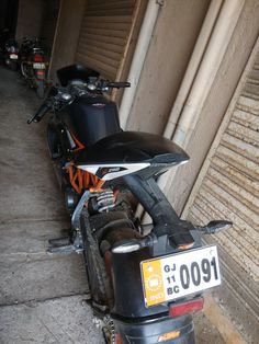 the back end of a motorcycle parked next to a building