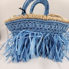 Caterina Bertini Fringe Mini Tote Bag In Blue Caterina Bertini Fringe Mini Tote Bag In Blue Retail $198 This Caterina Bertini Fringe Mini Tote Bag In Blue Is A Fashionable Addition To Any Woman's Collection. The Bag Features A Trapezoid Shape And A Blue Exterior Color. It Has Double Handles With A 5.12 Inch Drop And A Zip Closure For Security. The Bag Is Made Of A Woven Straw Exterior Material With A Viscose Nylon Blend Fabric Type And Has Gold Hardware Accents. The Bag Is Lined With A Blue Nylo Loungefly Purse, Fringe Tote Bag, Trapezoid Shape, Blue Exterior, Bags Game, Mini Blue, Boho Theme, Mini Tote Bag, Blue Interior