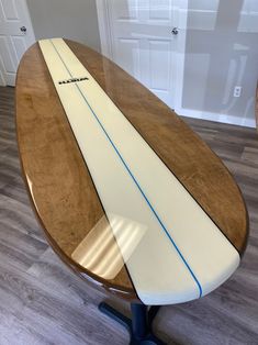 a surfboard sitting on top of a wooden table