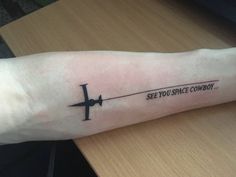 a person with a tattoo on their arm that says, see you space cowboy?