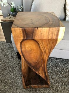 a wooden table sitting on top of a carpeted floor