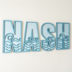 the word wash written in cut out letters on a white wall next to a clock