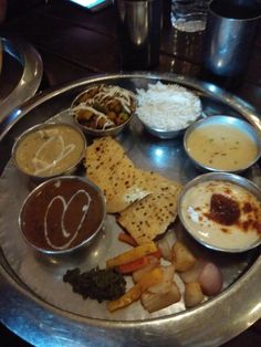 a silver plate topped with different types of food