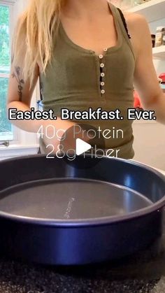 a woman standing in front of a pan on top of a counter