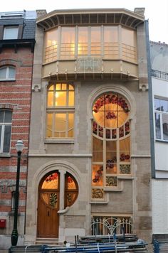 an old building with many windows and benches in front