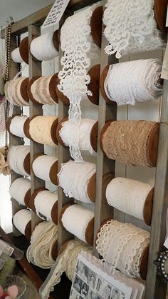 there are many rolls of yarn hanging on the wall