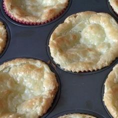 several freshly baked pies sitting in a muffin tin