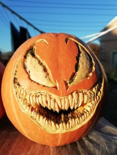 a carved pumpkin with its mouth open and teeth missing