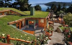 an aerial view of a house with a green roof