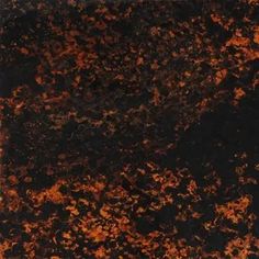 an orange and black marble textured with dark brown streaks on the surface, as seen from above