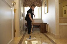 a man is cleaning the floor with a mop