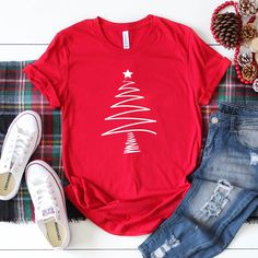 Womens Hand Drawn Christmas Tree Please Note: This Is A Unisex T Shirt So It Does Run A Little Bigger Than A Normal Woman’s Tee. If You Would Like A More Fitted Look Then Please Order A Size Down. Be Sure To Check The Photos For Exact Measurements. *Made By Ella + Brooks Co. In Texas, Usa *Pre-Shrunk *Machine Washable *100% Cotton *Bundle & Save Womens Funny Christmas Shirts If You Have Any Questions Or Need Assistance Please Feel Free To Reach Out. Follow Along @Ellaandbrooksco On Ig Casual Festive Tops For New Year, Casual T-shirt For Festive Holiday Season, Casual Holiday T-shirt For Festive Occasions, Casual Festive T-shirt For Holidays, Casual Festive Holiday T-shirt, Casual Holiday Festive T-shirt, Casual New Year Tops, Casual Red Top For New Year, Casual Holiday Tops For New Year