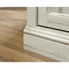 an old white door frame with wood flooring