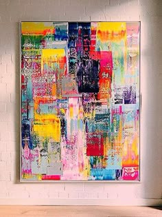 an abstract painting hangs on the wall