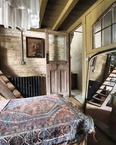 an old bedroom with a bed and stairs