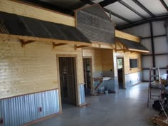 the inside of a building that is being built with wood and metal trimmings