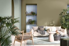 a living room filled with furniture and potted plants