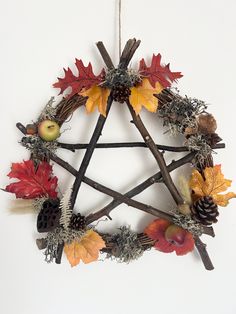 a wreath made out of branches, leaves and acorns