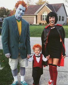 two adults and a child dressed up in costumes