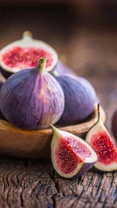 some figs are sitting on a wooden table