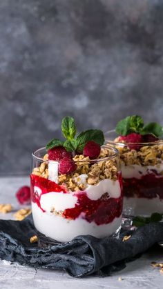 two desserts with raspberries and yogurt on top