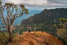 a person walking up a dirt road on top of a mountain