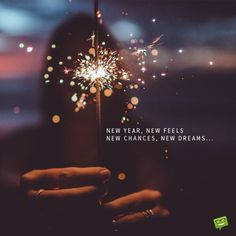 a person holding a sparkler in their hand with the words new year, new feels, new changes, new dreams