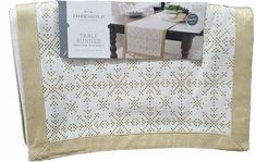 the table runner is white with gold trim