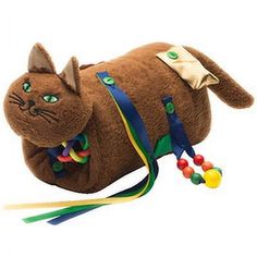 a stuffed cat is laying on its back with colorful beads around it's neck